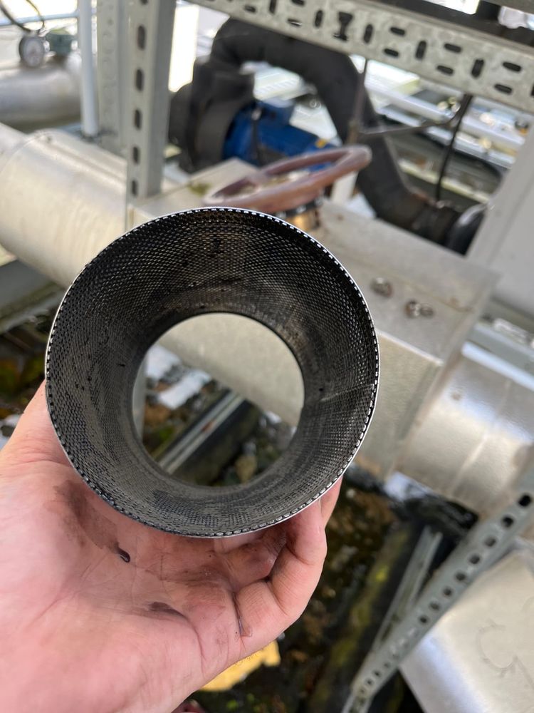 A large system strainer removed for cleaning on a commercial installation